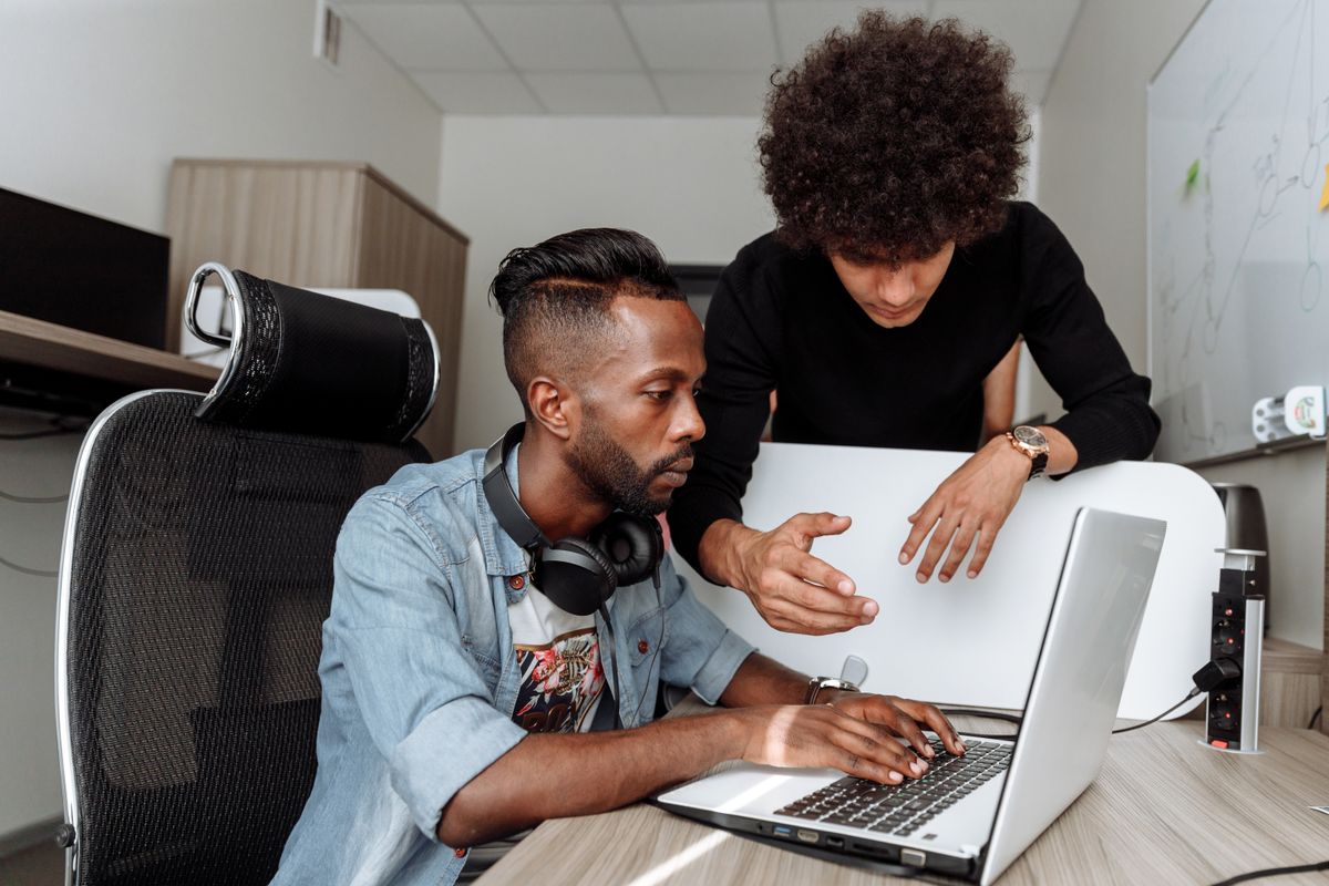 Colleagues collaborating over a laptop
