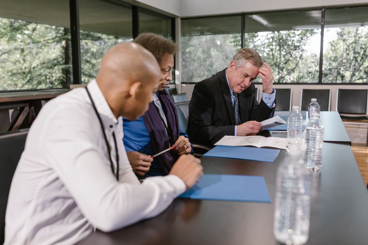 Team reviewing compliance documents in a meeting